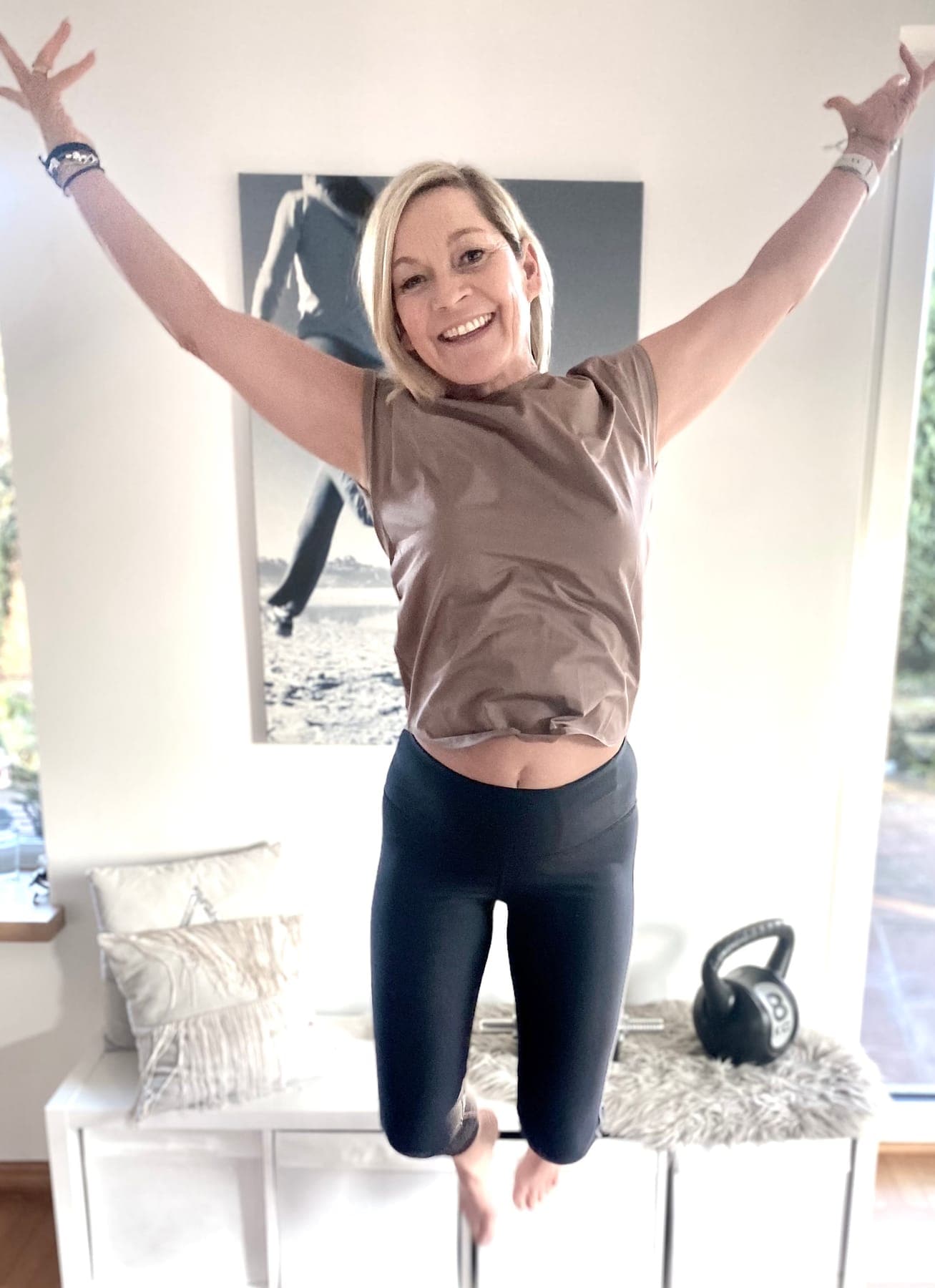Sabine Wahl mit erhobenen Armen in ihrem Trainingsraum